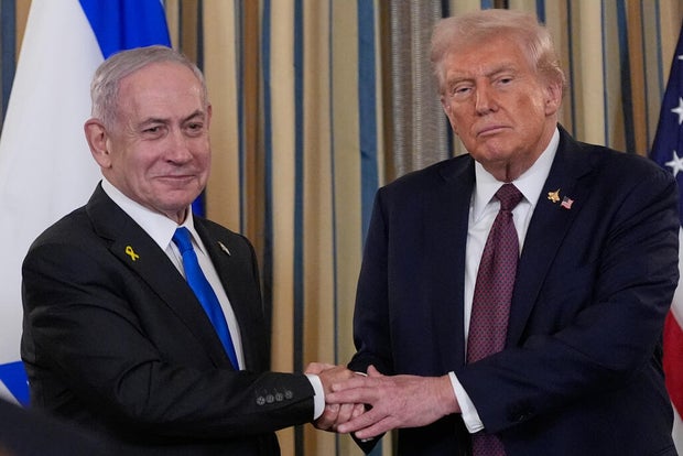 Israel's Prime Minister Benjamin Netanyahu shakes hands with President Donald Trump 