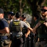 Agents from the Homeland Security Investigations unit, U.S. Park Police officers, and U.S. Secret Service Uniformed Division officers conduct a traffic stop near the White House in Washington, D.C., on Aug. 26, 2025. 