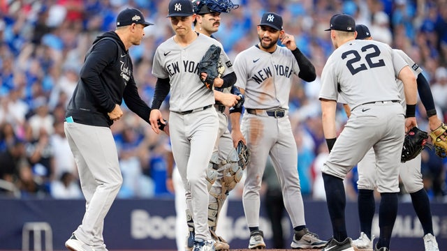 Manager Aaron Boone #17 of the New York Yankees removes Luke Weaver #30 from the seventh inning of game one of the Division Series against the Toronto Blue Jays at Rogers Centre on October 04, 2025 in Toronto, Ontario. 