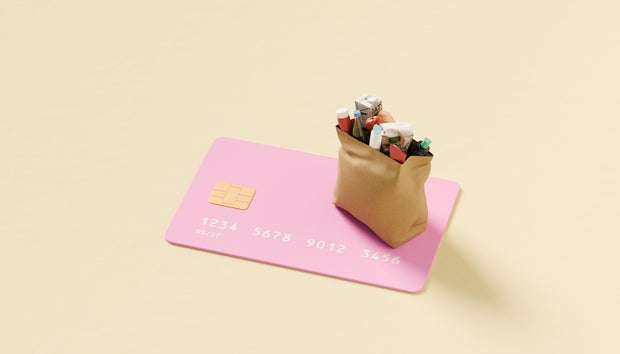 Grocery bag on top of oversized credit card