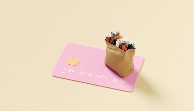 Grocery bag on top of oversized credit card 