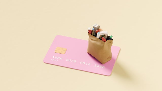 Grocery bag on top of oversized credit card 
