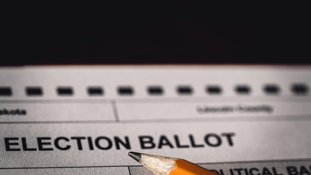 Selective focus on a generic election ballot with a pencil on top. 