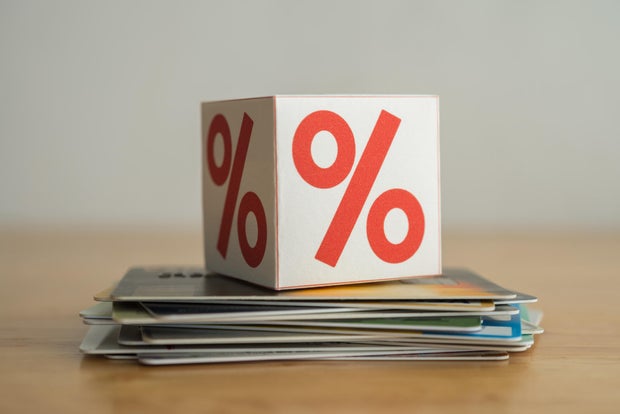 Close up interest rate symbol box on many credit card white background.