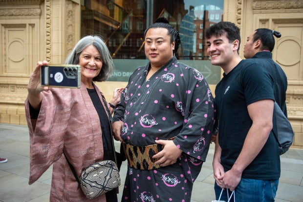 Fans of the sumo wrestling take a selfie with the Japanese