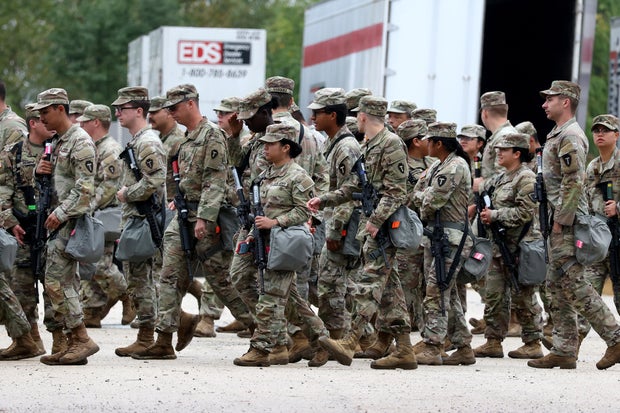 Members of the Texas National Guard assemble at the Army Reserve Training Center in Elwood, Illinois, on Tuesday, Oct. 7, 2025. 