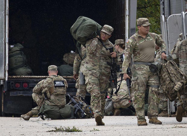 Members of the Texas National Guard arrive on Oct. 7, 2025, at the Army Reserve Training Center in Elwood, Illinois. 