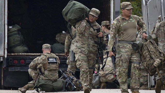 Members of the Texas National Guard assemble at the Army Reserve Training Center in Elwood, Illinois, on Tuesday, Oct. 7, 2025. 