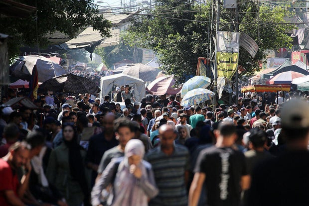 Palestinians gather at a market in Deir el-Balah in the central Gaza Strip 