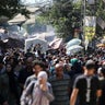 Palestinians gather at a market in Deir el-Balah in the central Gaza Strip 