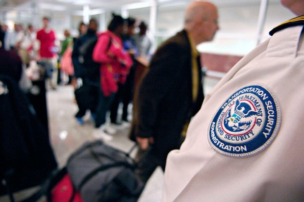 A Transportation Security Administration (TSA) employee stan
