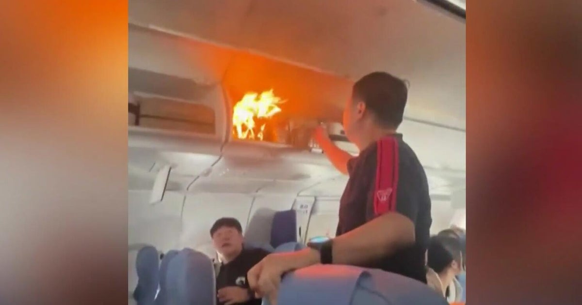 Lithium-ion battery sparks fire in overhead luggage compartment during flight to China Lithium-ion battery sparks fire in overhead luggage compartment during flight to China