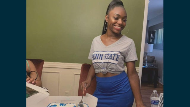 Kada Scott wears a Penn State t-shirt, smiling as she's about to cut into a cake 