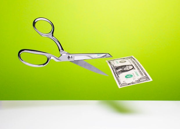 Cutting the budget - Scissors and dollar 