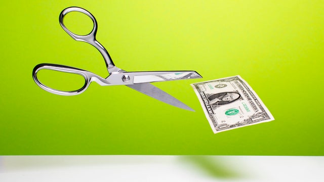 Cutting the budget - Scissors and dollar 