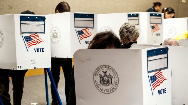 People take part in early voting at a polling center in the Manhattan borough of New York City on October 25, 2025.