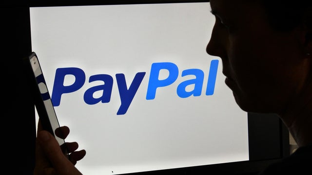 :Silhouette of upset Australian woman over PayPal logo
