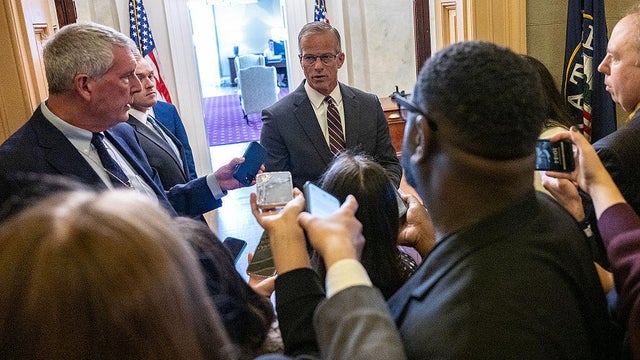 Reporters ask questions as Senate Majority Leader John Thune of South Dakota enters his office at the U.S. Capitol in Washington, D.C., on Oct. 29, 2025.