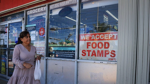 A sign reading "We Accept Food Stamps" hangs in the window of a grocery store in Miami on Oct. 31, 2025.