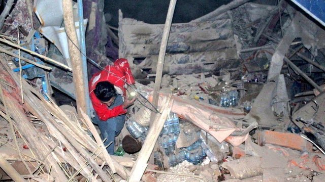 A rescuer works following an earthquake at an unidentified location in Afghanistan 