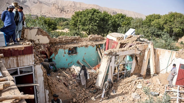 A rescuer works following an earthquake at an unidentified location in Afghanistan 