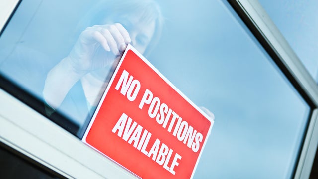 NO POSITION AVAILABLE Sign on Retail Display Window for Economic Recession 
