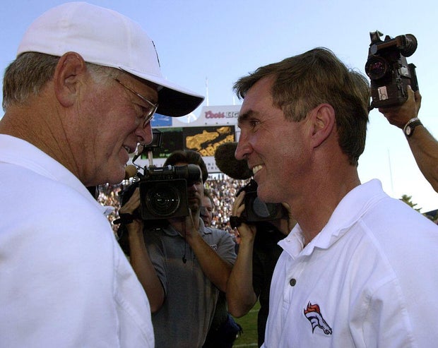 DENVER, CO--BRONCOS vs FALCONS--Atlanta Falcons coach Dan Reeves meets with broncos coach Mike Shanahan at mid field after the Broncos win over the Falcons 42-14 for the Broncos first regular season win.THE DENVER POST/JOHN LEYBA 2000 DIGITAL FILE 