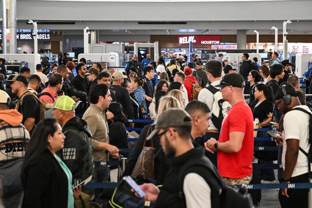 Travelers wait in line at a security checkpoint at George Bush Intercontinental Airport in Houston, Texas, Nov. 7, 2025.