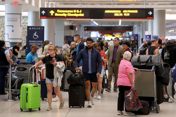 Travelers pass through Miami International Airport on Nov. 10, 2025, in Miami, Florida. 