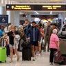 Travelers pass through Miami International Airport on Nov. 10, 2025, in Miami, Florida. 