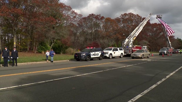 A large American flag over a street