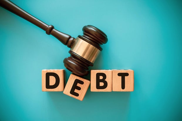 Gavel and wood   artifact  with DEBT 