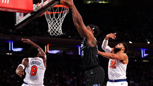 Wendell Carter Jr. #34 of the Orlando Magic dunks the ball against OG Anunoby #8 and Karl-Anthony Towns #32 of the New York Knicks in the third quarter at Madison Square Garden on November 12, 2025 in New York City. 