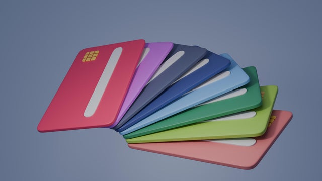 A row of colorful credit cards are displayed in a row 