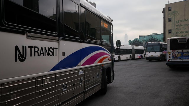 A commuter boards a NJ Transit bus bound for New York City at the Allwood Park and Ride stop in Clifton, N.J. on May 19, 2025. 