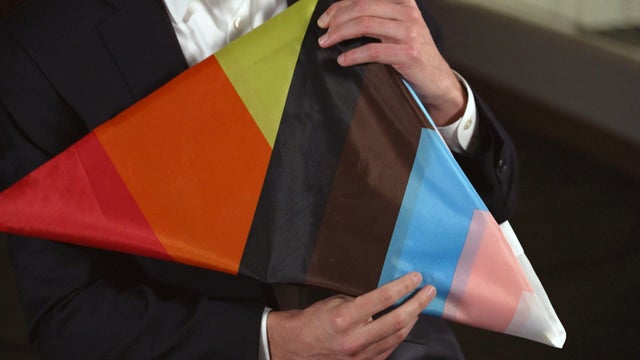 David Maltinsky holding a Pride flag