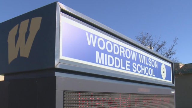 diminishing perspective of row of traditional metal school lockers 