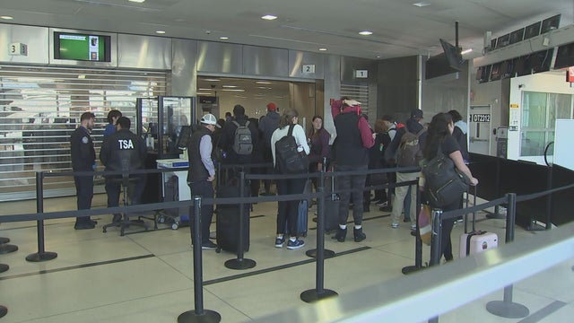 People wait in line at Philadelphia International Airport 