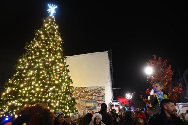 People pose for photos during a holiday event in Manayunk 
