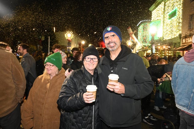 People pose for photos during a holiday event in Manayunk 