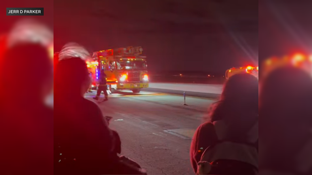 Emergency crews on the runway at Philadelphia International Airport after an American Eagle flight was evacuated