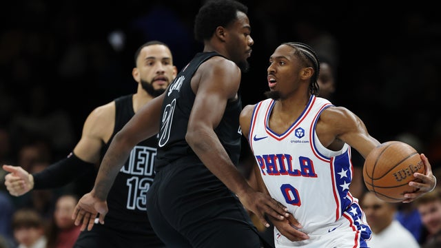 Tyrese Maxey #0 of the Philadelphia 76ers looks to pass as Day'Ron Sharpe #20 and Tyrese Martin #13 of the Brooklyn Nets defend during the first half at Barclays Center on November 28, 2025 in the Brooklyn borough of New York City. 