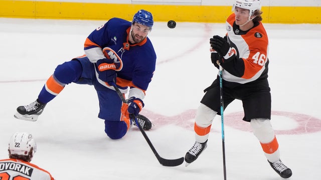 New York Islanders Defenseman Adam Pelech (3) and Philadelphia Flyers Center Trevor Zegras (46) battle for the puck during the second period of the National Hockey League game on November 28, 2025, at UBS Arena in Elmont, NY. 