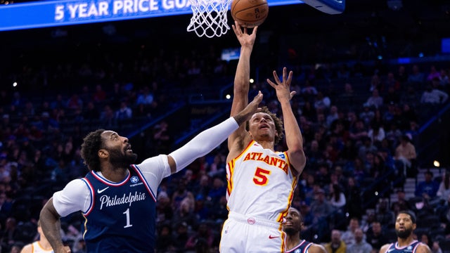 Atlanta Hawks' Dyson Daniels, right, shoots the ball with Philadelphia 76ers' Andre Drummond defending during the first half of an NBA basketball game in Philadelphia 