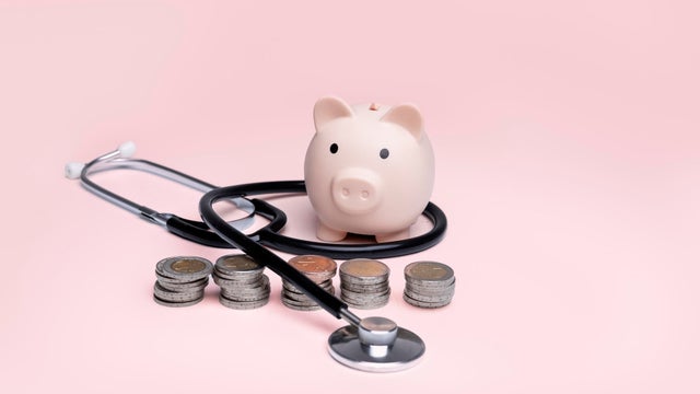 Piggy bank with coins and a stethoscope,Health insurance and savings concept,Health and money,Savings and pet insurance,Health insurance,Pet health insurance 