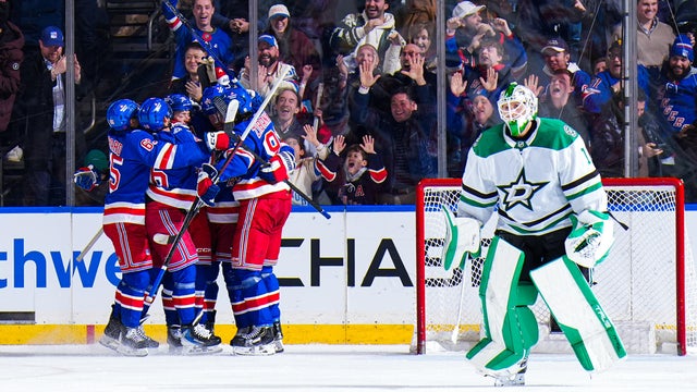 Vladislav Gavrikov #44 of the New York Rangers celebrates with teammates after scoring the game winning goal in overtime against Casey DeSmith #1 of the Dallas Stars at Madison Square Garden on December 2, 2025 in New York City. 