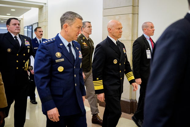 Navy Adm. Frank Bradley, accompanied by Chairman of the Joint Chiefs of Staff Air Force Gen. Dan Caine, arrives for a closed door classified meeting with lawmakers on Capitol Hill on Dec. 4, 2025 in Washington, D.C. 