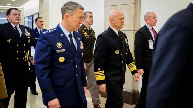 Navy Adm. Frank Bradley, accompanied by Chairman of the Joint Chiefs of Staff Air Force Gen. Dan Caine, arrives for a closed door classified meeting with lawmakers on Capitol Hill on Dec. 4, 2025 in Washington, D.C. 