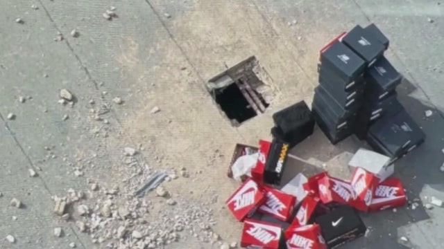 Close Up Shot Focused on Yellow Tape Showing Text Police Line Do Not Cross. Restricted Area of a Crime Scene. Bokeh Background with Flickering Siren Lights. Forensics Team Working on a Case 