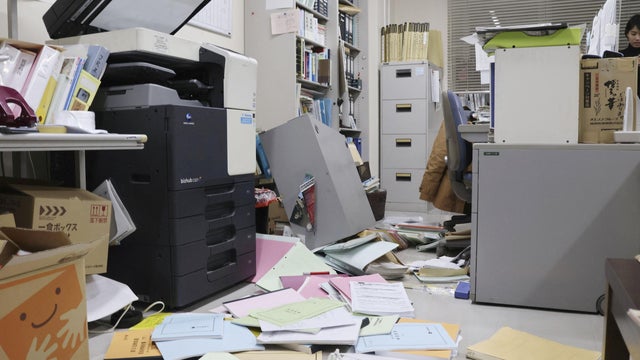 Bookshelves and documents that fell during an earthquake are seen at Kyodo News' Hakodate bureau in Hakodate, Hokkaido, Japan, Dec. 8, 2025, in this photo taken by Kyodo. 